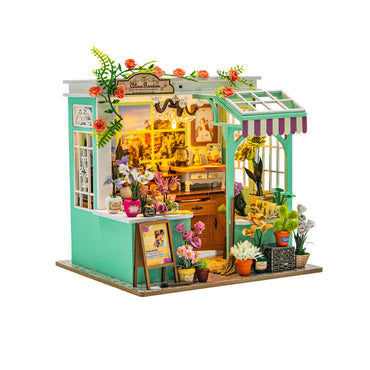 Miniature model of a flower shop with detailed interior and exterior on a white background